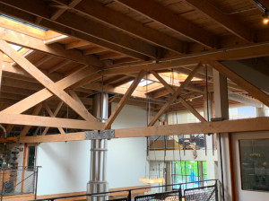 An interior space with crisscrossing wooden beams